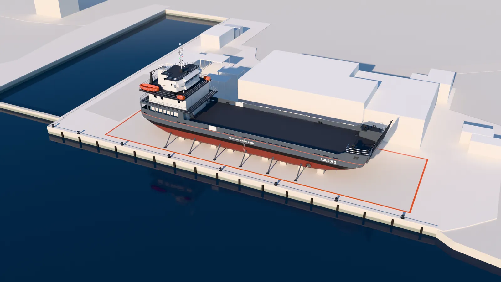 Illustration: aerial view of our shipyard at Fomar, Shiroda, Goa, with LOURDES shown complete on keel blocks inside the 67.5 m by 20 m ship building area beside the waterfront quay, the yard buildings and a walled basin behind